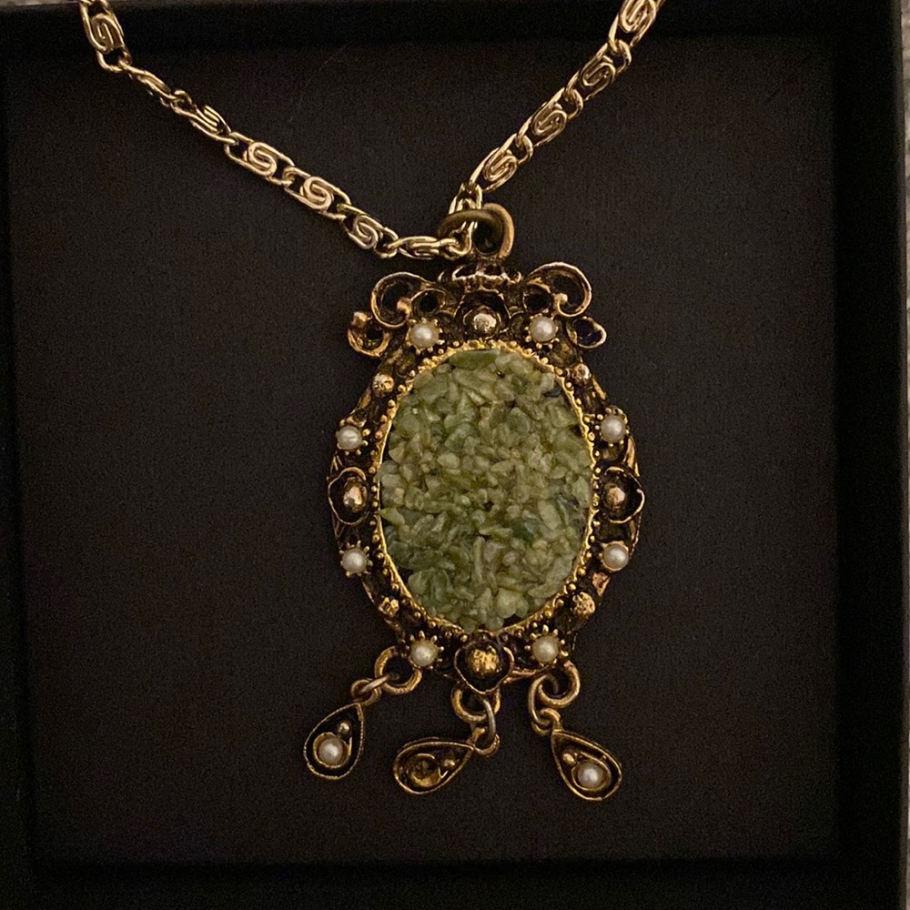 Gold statement necklace with green stone and pearl detailing